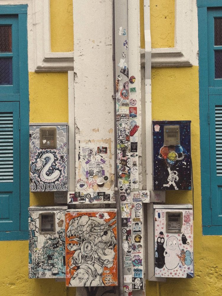 Painted meter boxes on a yellow wall